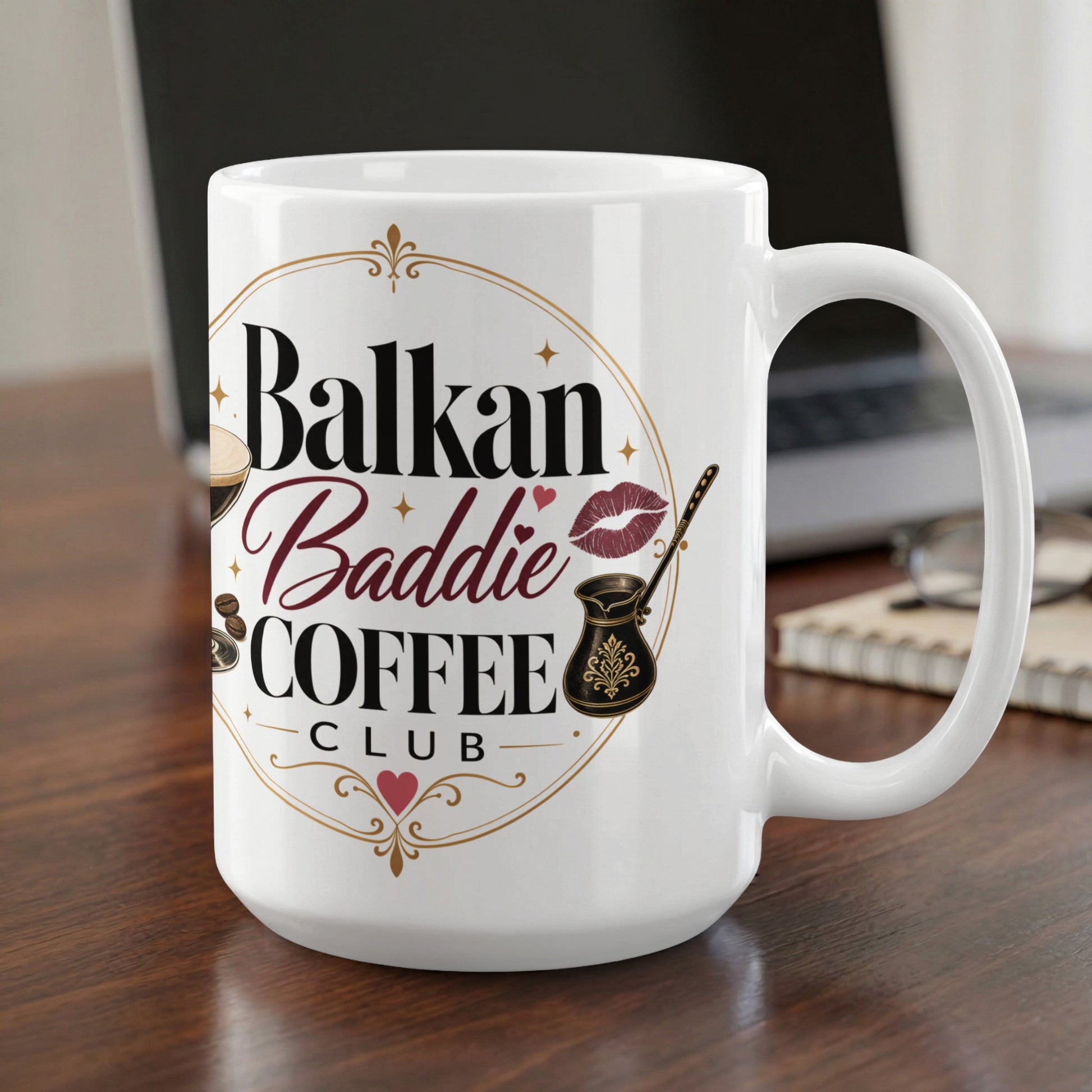 White mug with "Balkan Baddie Coffee Club" text and coffee-related graphics.
