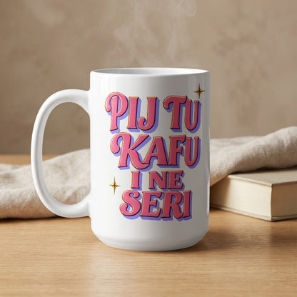 White mug with text "PIJ TU KAFU I NE SERI" and steam rising.