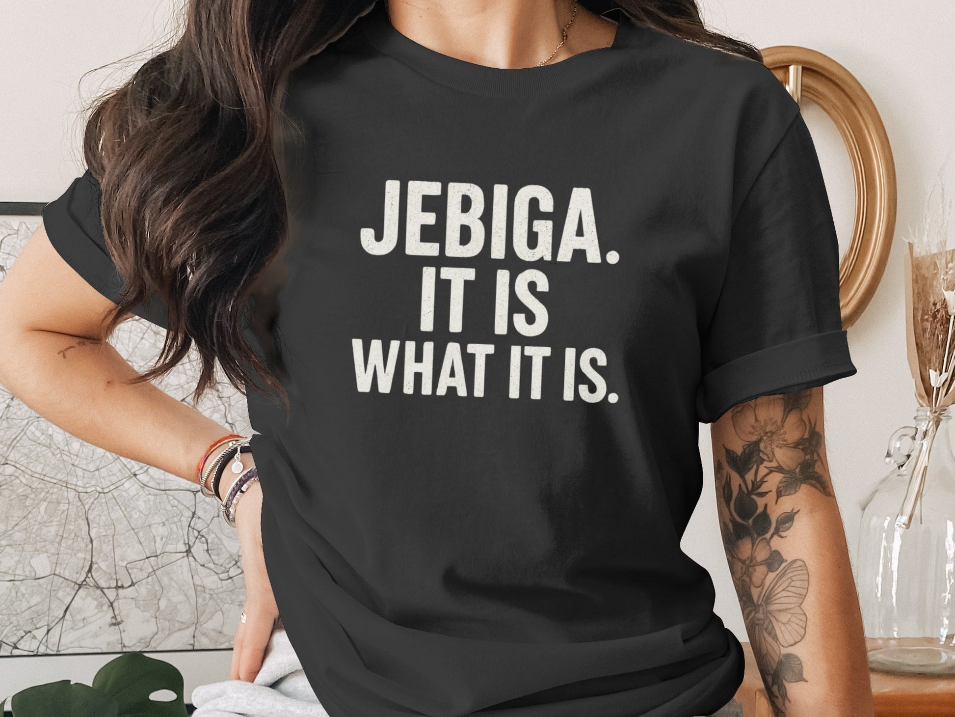 Black t-shirt with white text reading "JEBIGA. IT IS WHAT IT IS."
