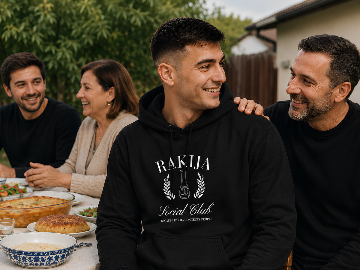 Woman wearing a black Raised Balkan T-shirt with a family member