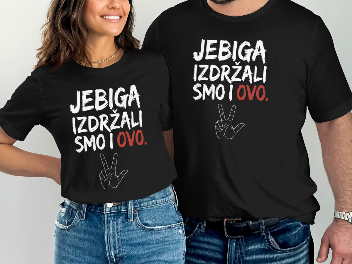 A woman and a man wear matching black t-shirts printed with white text and a red word.