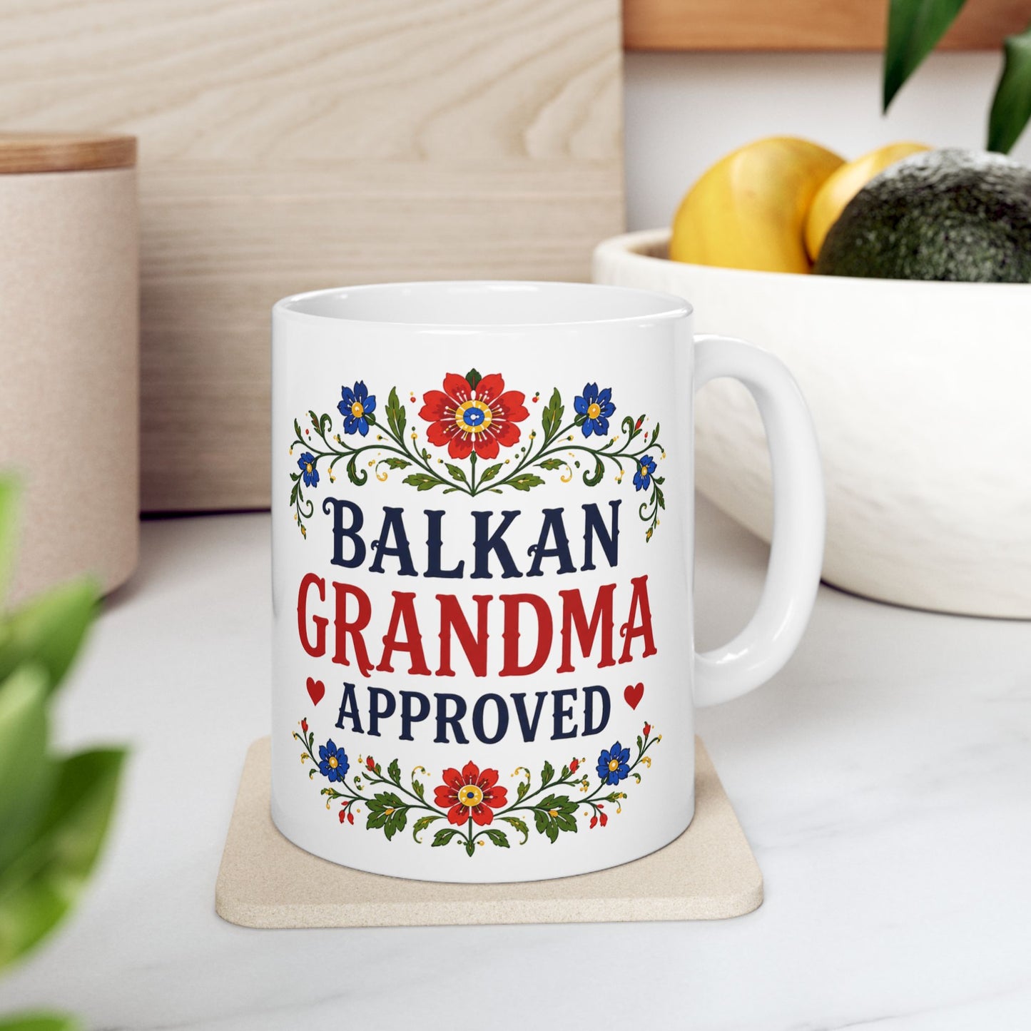 White mug with "Balkan Grandma Approved" text and floral design.