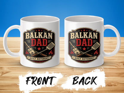 White mug with "Balkan Dad Built Different" text and barbecue graphics.