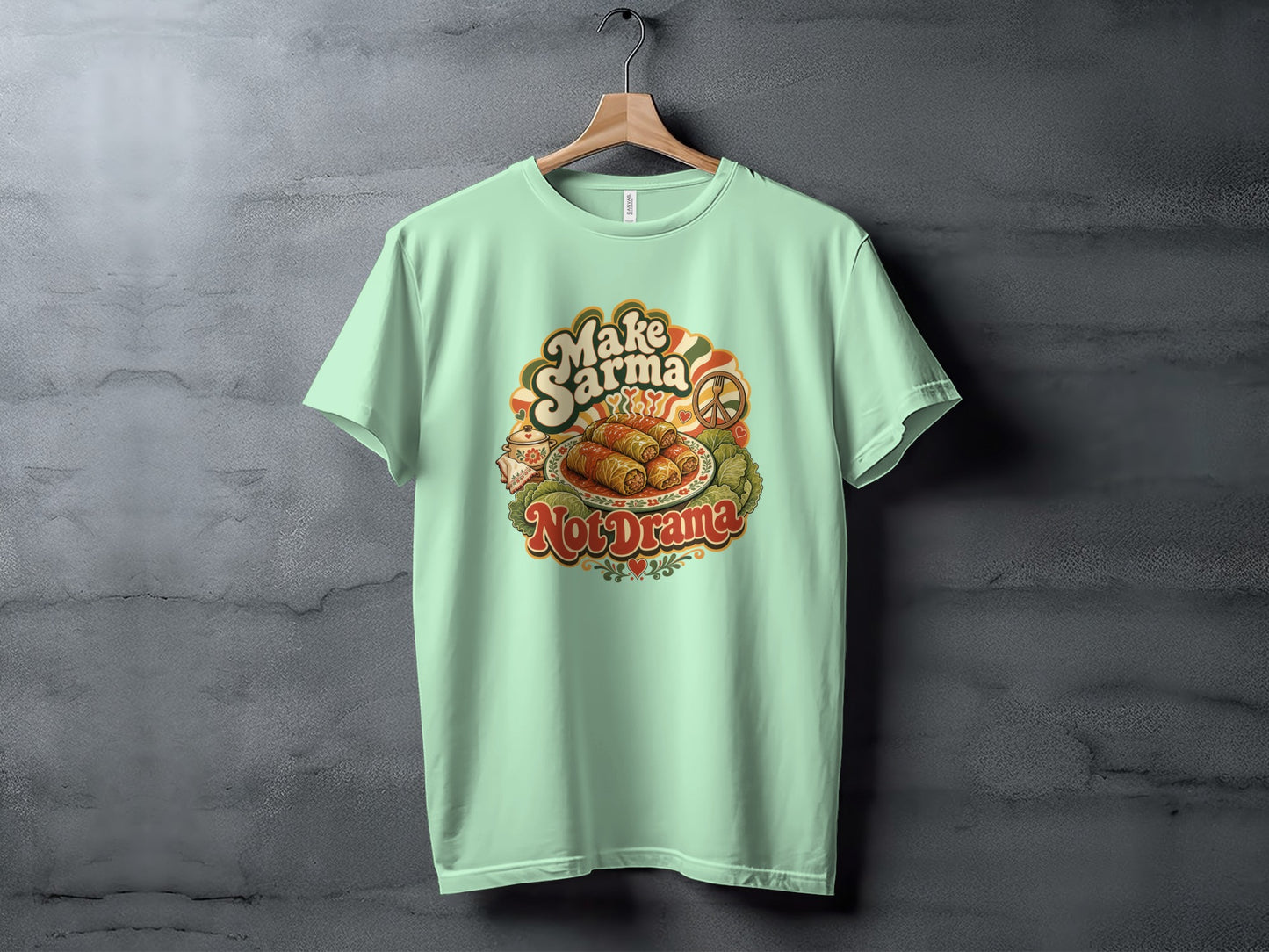 Mint green t-shirt with "Make Sarma Not Drama" text and graphic of food.