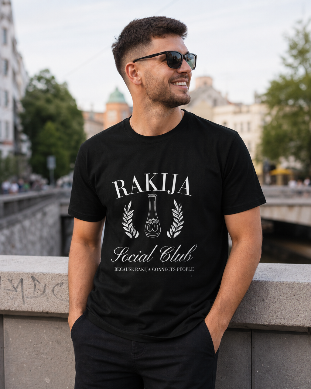 Man wearing a Rakija slogan T-shirt in a rustic Balkan-style bar