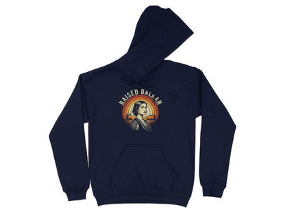Navy hoodie with "Raised Balkan" text and a vintage sunset graphic.
