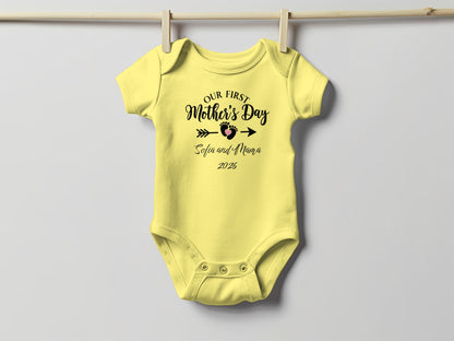 Yellow baby onesie with "Our First Mother's Day Sofia and Mama 2026" text.