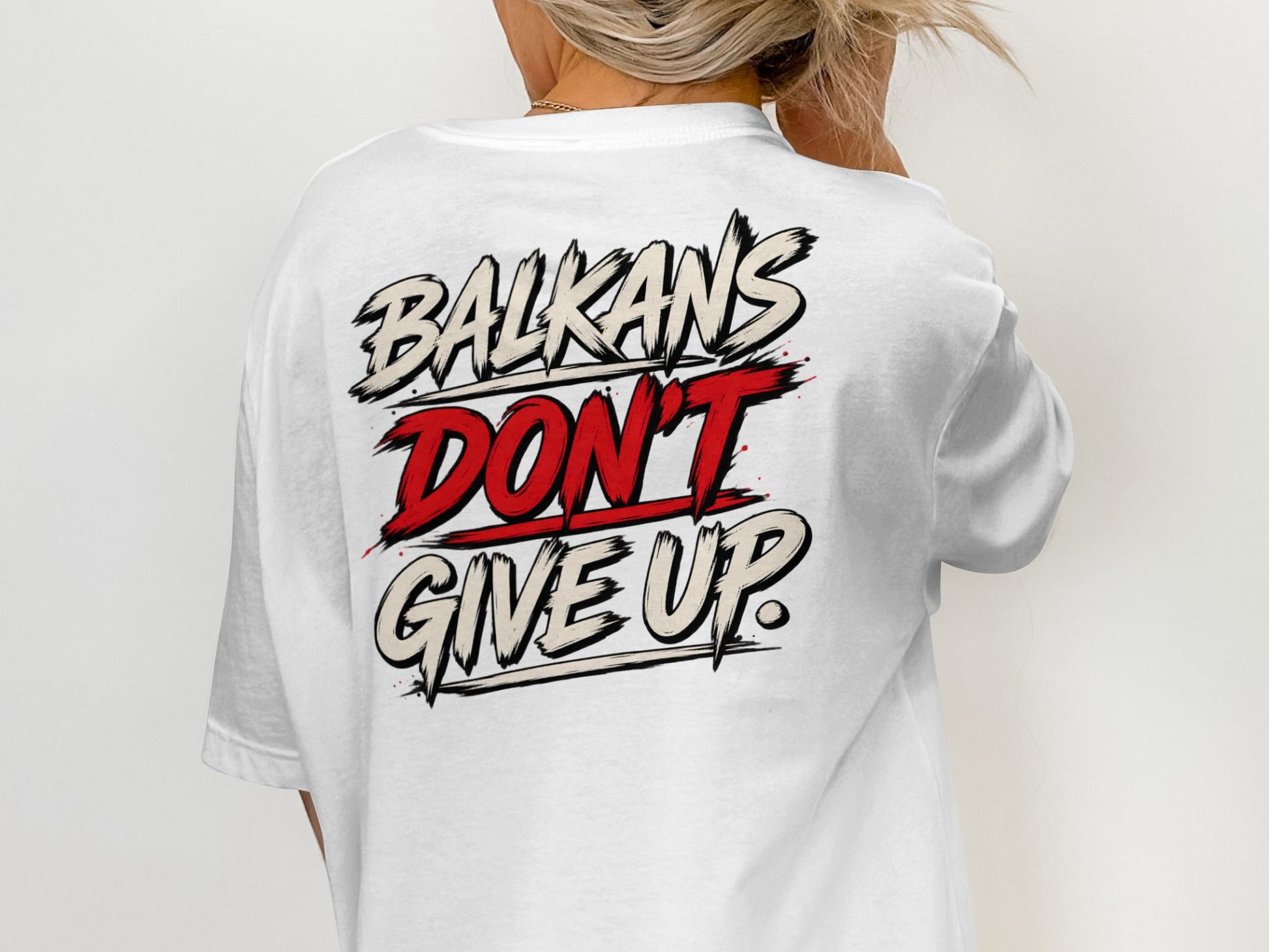 White t-shirt with "BALKANS DON'T GIVE UP" graphic design.