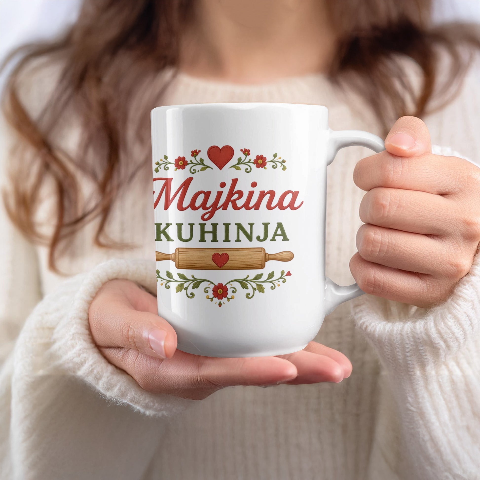 White mug with "Majkina KUHINJA" text and decorative floral elements.