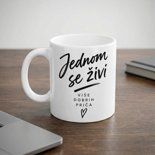 White mug with black text reading "Jednom se živi" and "VIŠE DOBRIH PRIČA".
