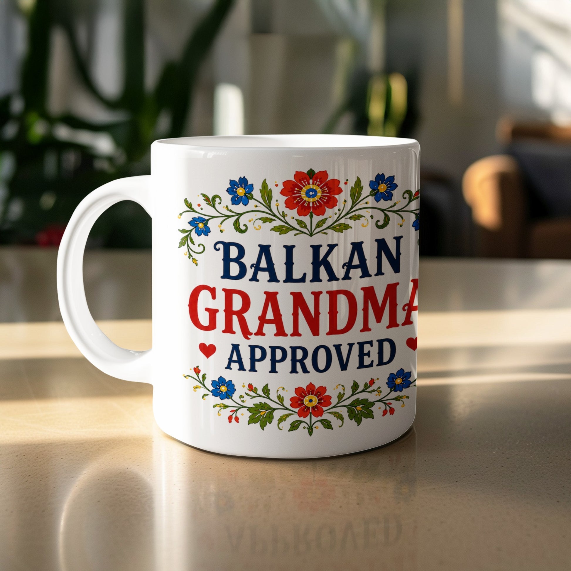 White mug with "Balkan Grandma Approved" text and floral border.