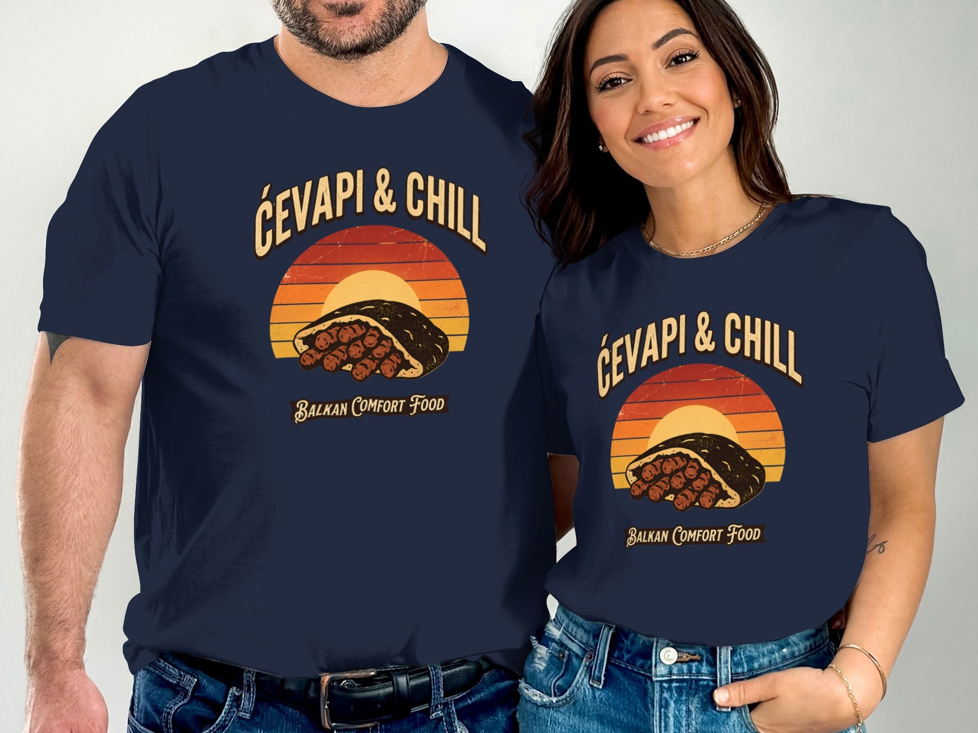 Navy shirts with retro graphic of ćevapi sandwich and sunset, text "Ćevapi & Chill Balkan Comfort Food".