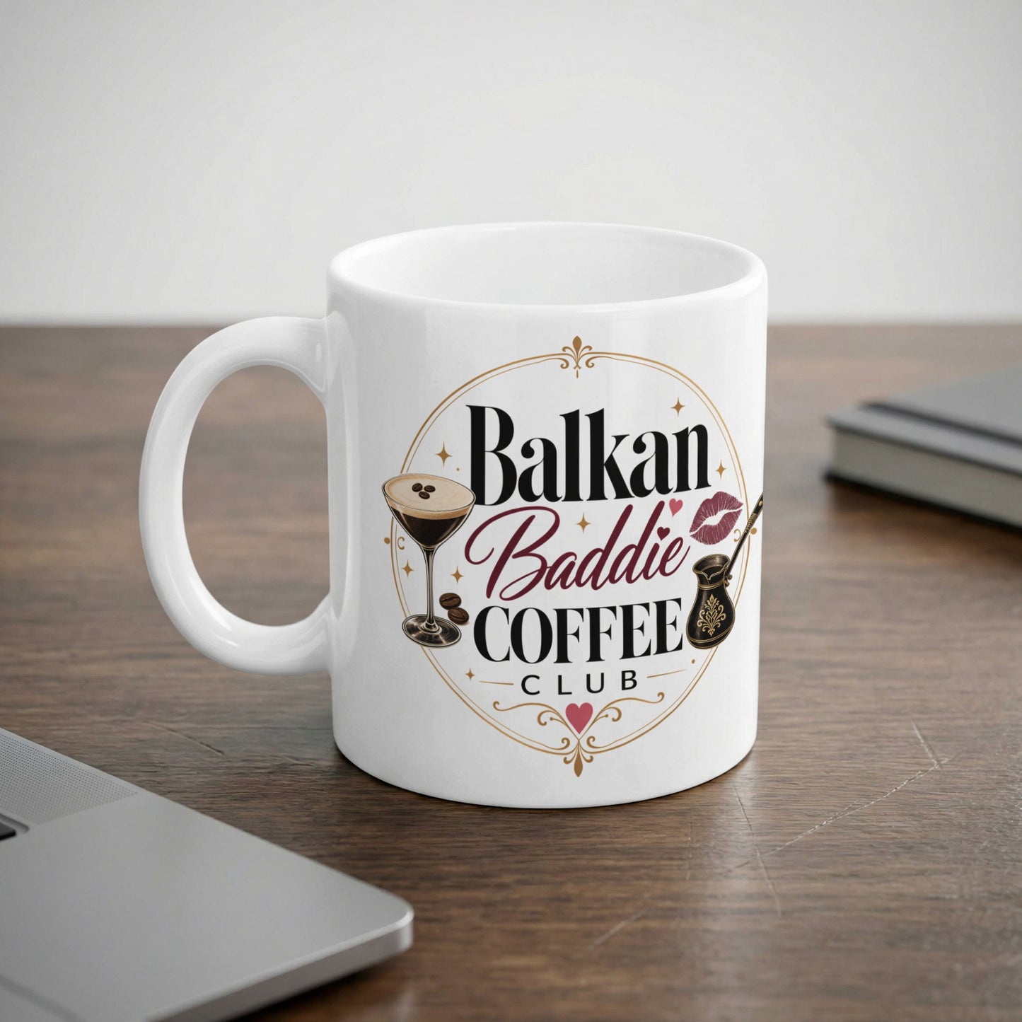 White mug with "Balkan Baddie Coffee Club" text and coffee-themed graphics.