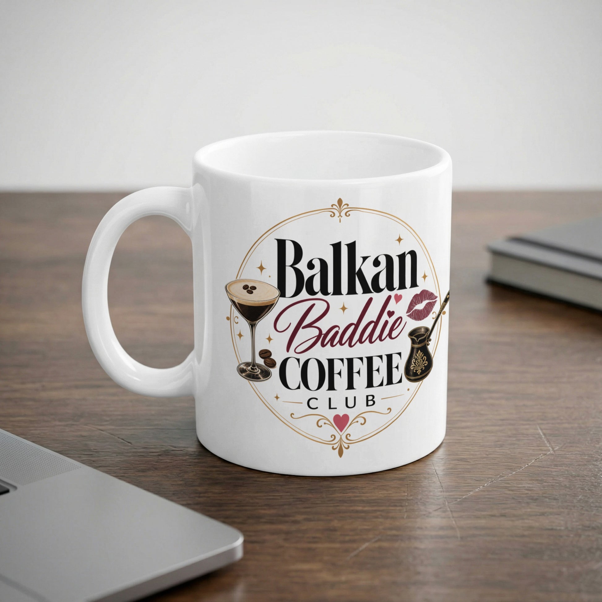 White mug with "Balkan Baddie Coffee Club" text and coffee-themed graphics.