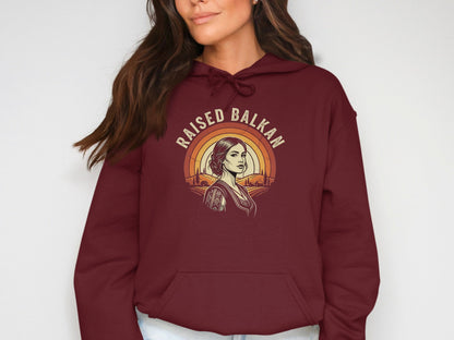 Maroon hoodie with "Raised Balkan" text and a woman with traditional clothing.