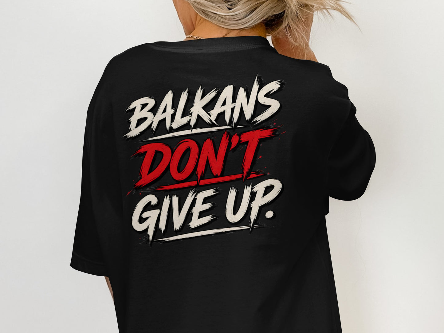 Black t-shirt with "BALKANS DON'T GIVE UP." text design on the back.