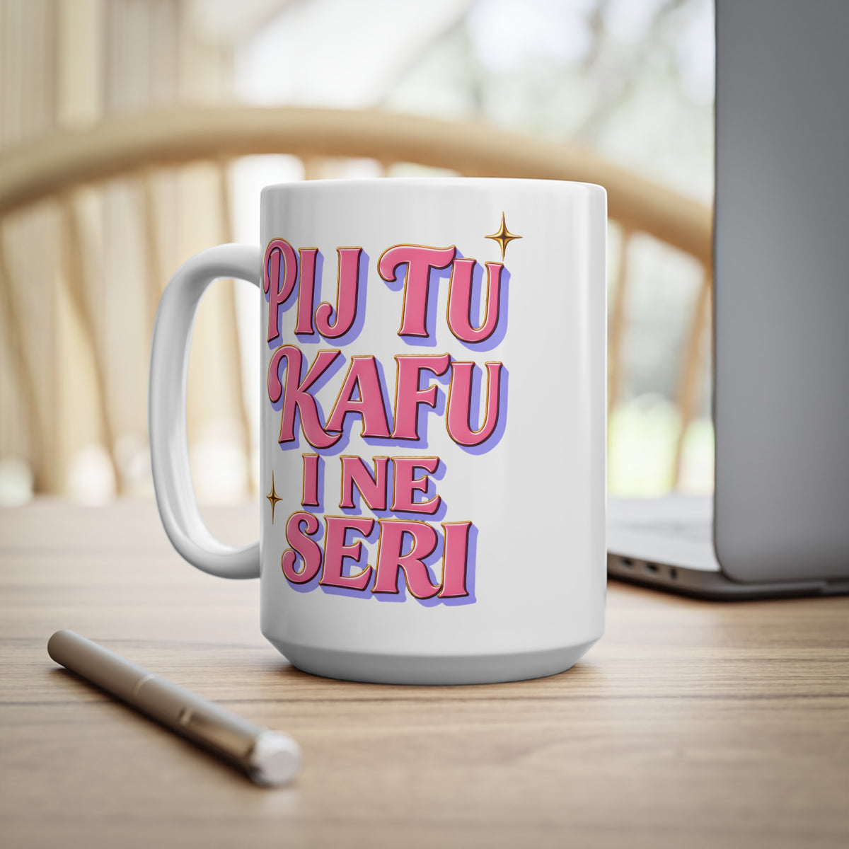 White mug with pink and purple text that reads "PIJ TU KAFU I NE SERI".