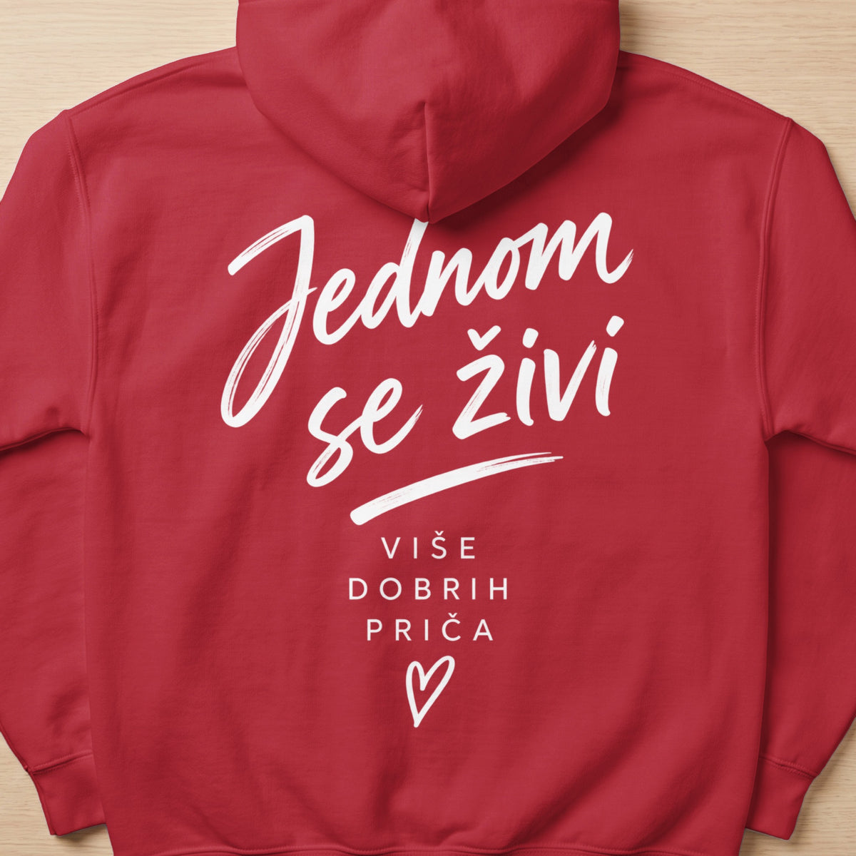 Red hoodie with white text "Jednom se živi Više dobrih priča" and a heart.