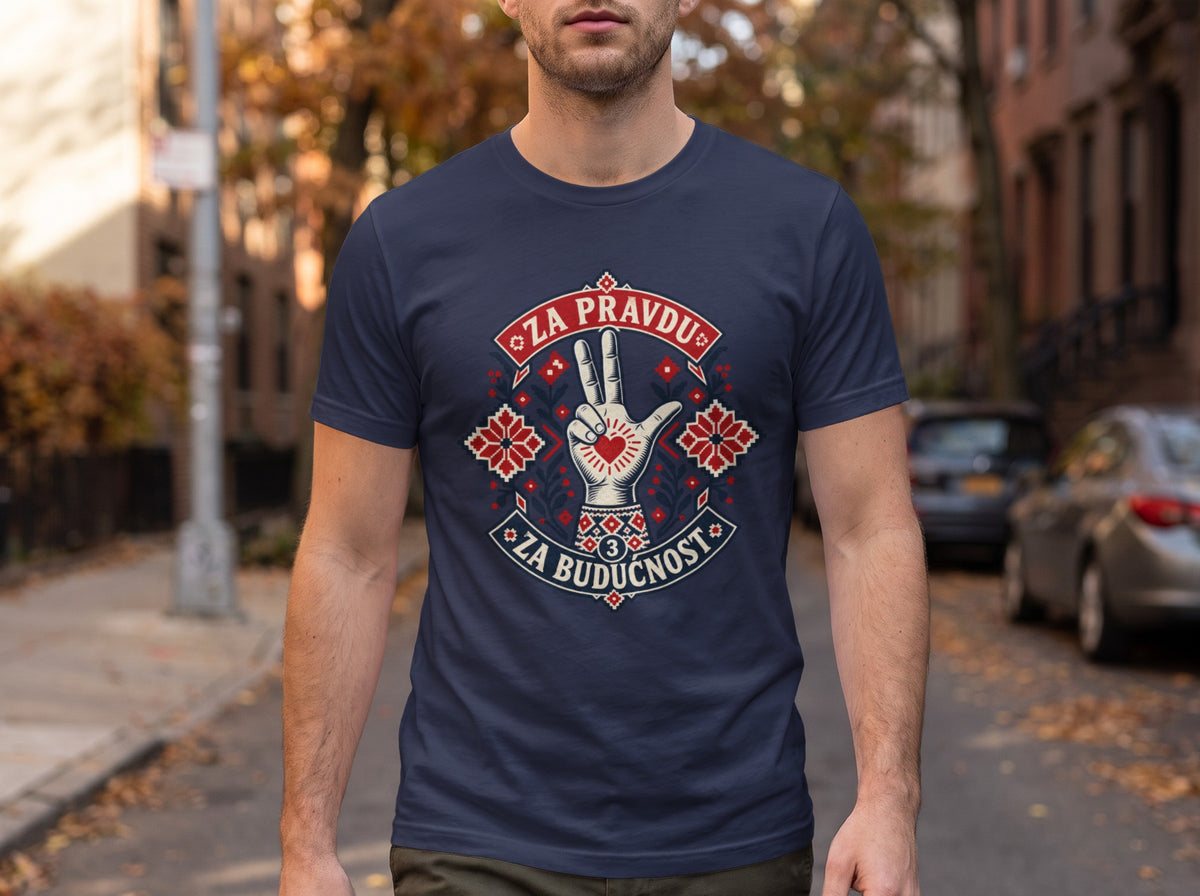 A man standing outdoors wears a dark blue t-shirt featuring a stylized hand graphic with a heart and embroidered patterns, flanked by the text "Za pravdu" and "Za buducnost."
