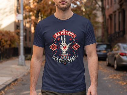 A man standing outdoors wears a dark blue t-shirt featuring a stylized hand graphic with a heart and embroidered patterns, flanked by the text "Za pravdu" and "Za buducnost."