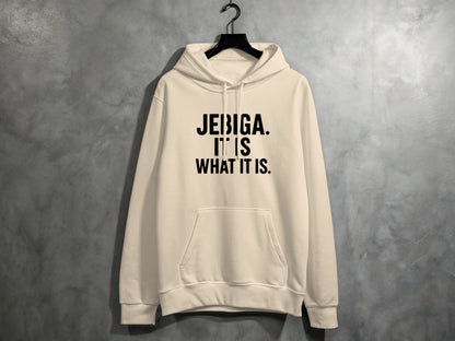 Cream hoodie with black text that reads "JEBIGA. IT IS WHAT IT IS."