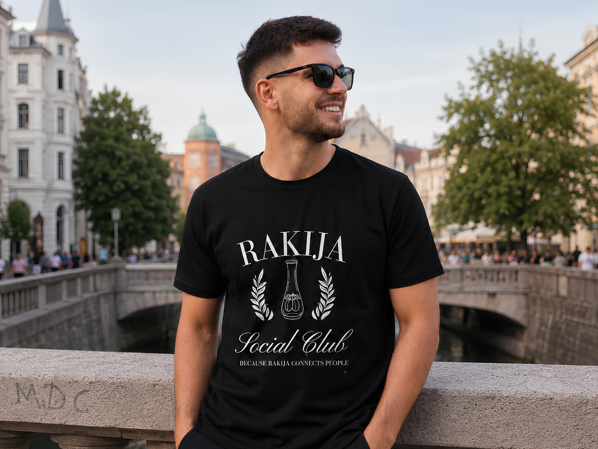 Man wearing a Rakija slogan T-shirt in a rustic Balkan-style bar