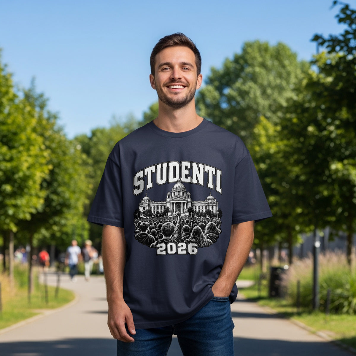 A smiling man wearing a dark blue t-shirt featuring a building graphic and text.