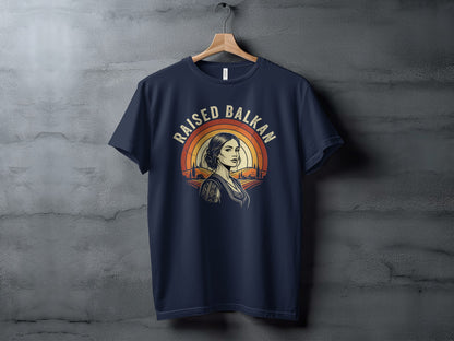 Navy t-shirt with Raised Balkan design featuring woman and sunset.