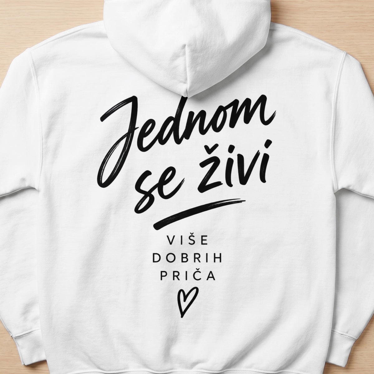 White hoodie with black text "Jednom se živi" and "Više dobrih priča" with a heart.