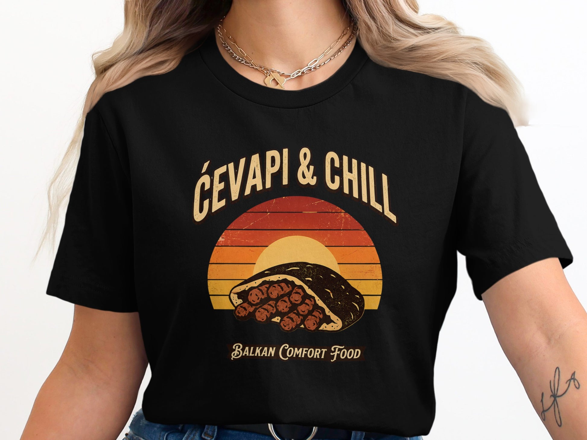Black t-shirt with graphic featuring cevapi, "Čevapi & Chill", and "Balkan Comfort Food".