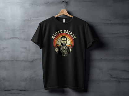 Black t-shirt with "Raised Balkan" text and a man in traditional clothing.