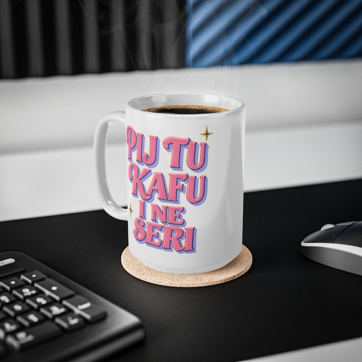 White mug with pink and purple text reading "PIJ TU KAFU I NE SERI" on a desk.