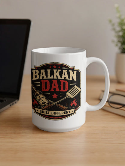 White mug with "BALKAN DAD BUILT DIFFERENT" and grill tools design.