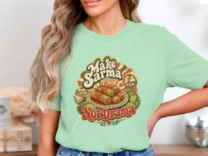 Mint green t-shirt with "Make Sarma Not Drama" text and food illustration.