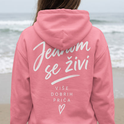 Pink hoodie with white text "Jesnom se živi" and "Više dobrih priča" with heart.