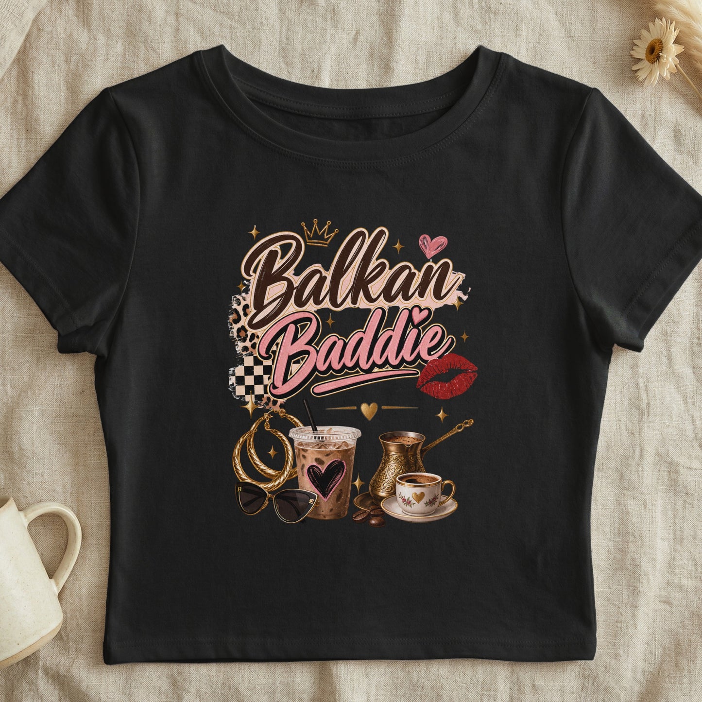 Black t-shirt with "Balkan Baddie" text, crown, coffee, and accessories graphic.