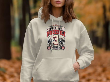 A woman wearing a white hoodie featuring a graphic with the text "STUDENTI SU POBEDILI" and "SRBIJA 2026".
