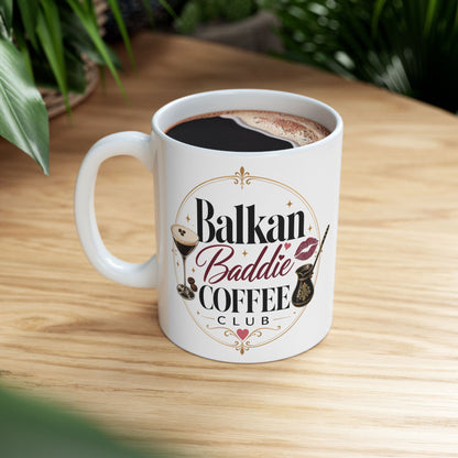 White mug with "Balkan Baddie Coffee Club" text and graphics.