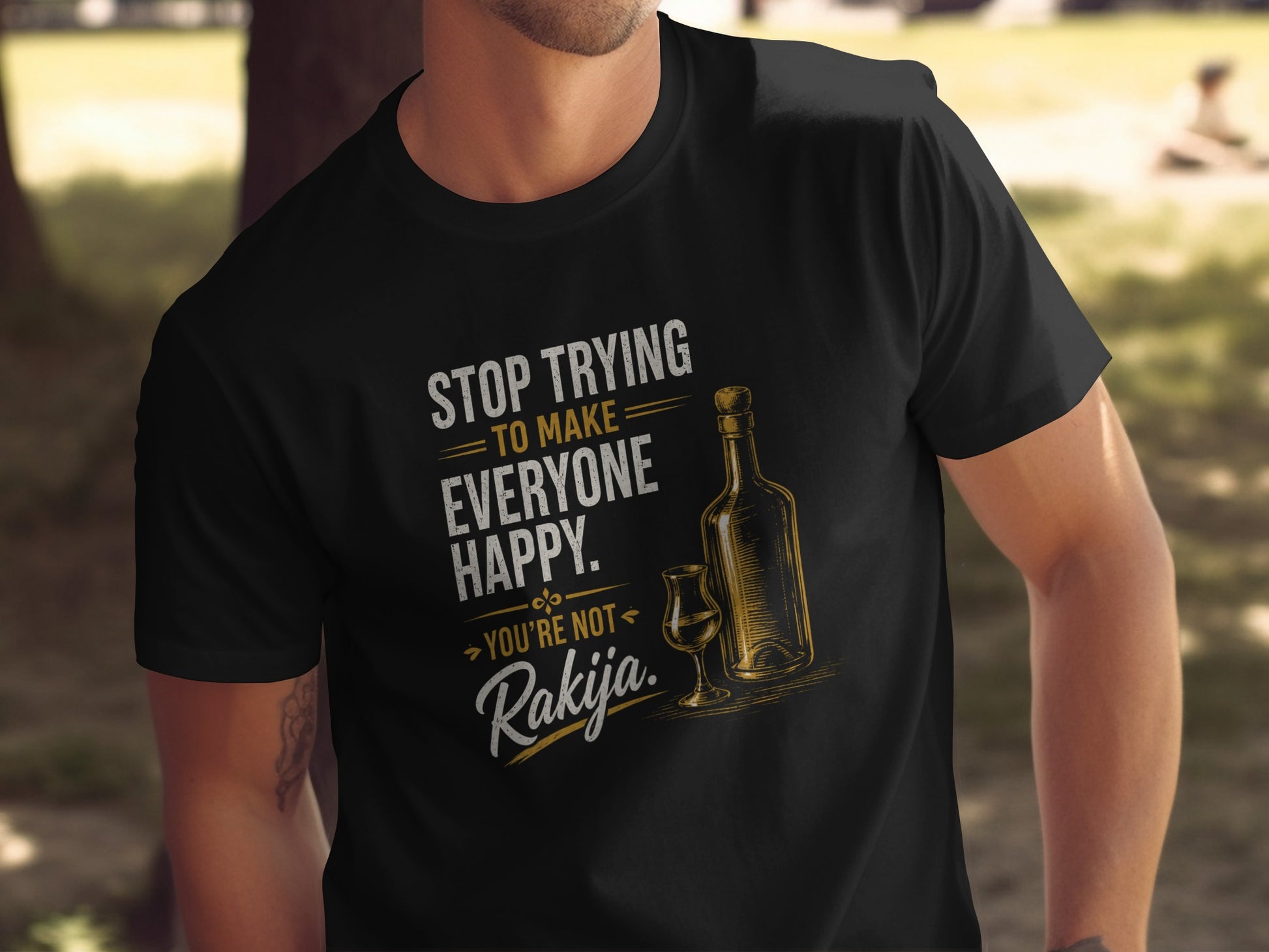 Black shirt with "Stop trying to make everyone happy. You're not Rakija." text and bottle.