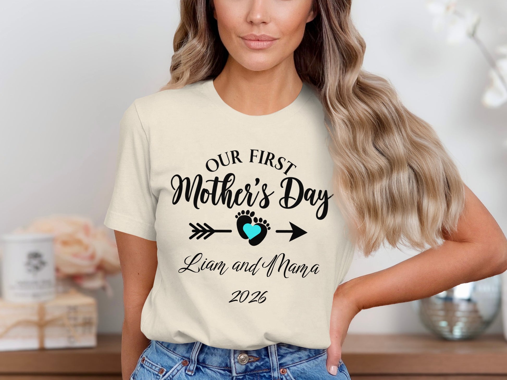 Cream t-shirt with "Our First Mother's Day" text, heart, arrow, and "Liam and Mama 2026."