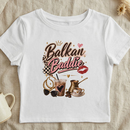 White t-shirt with "Balkan Baddie" text, crown, heart, and coffee cup graphic.