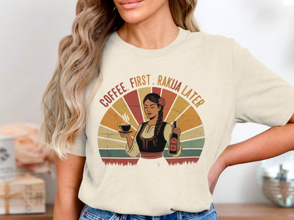 Woman wearing retro shirt holding coffee and rakia bottle with text.