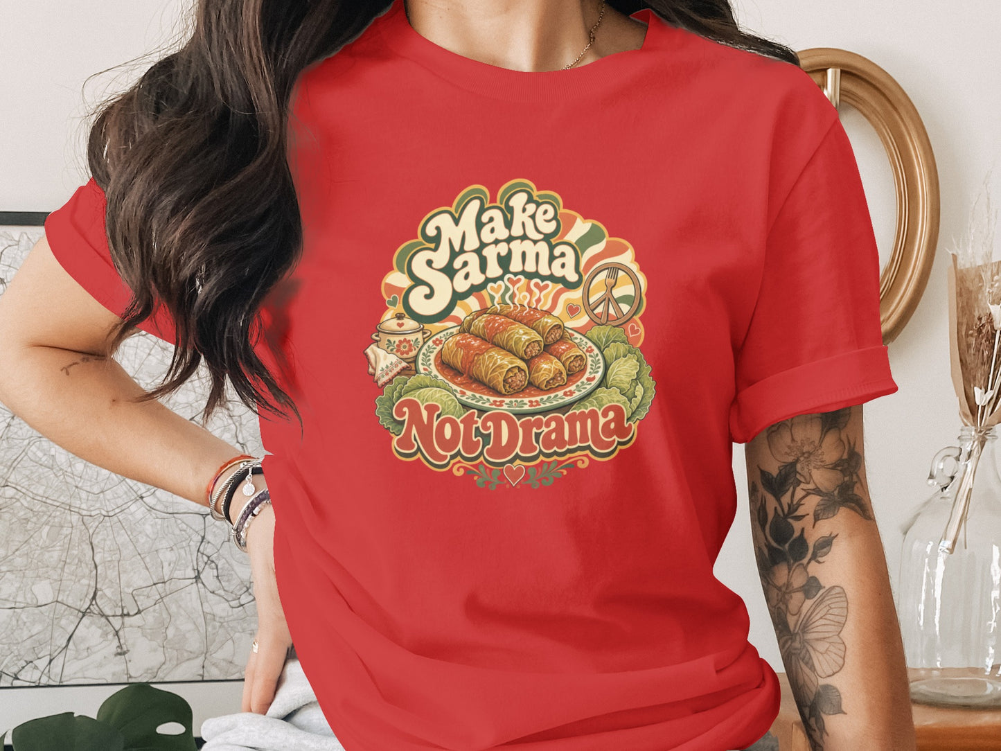 Red t-shirt with "Make Sarma, Not Drama" text and sarma dish graphic.