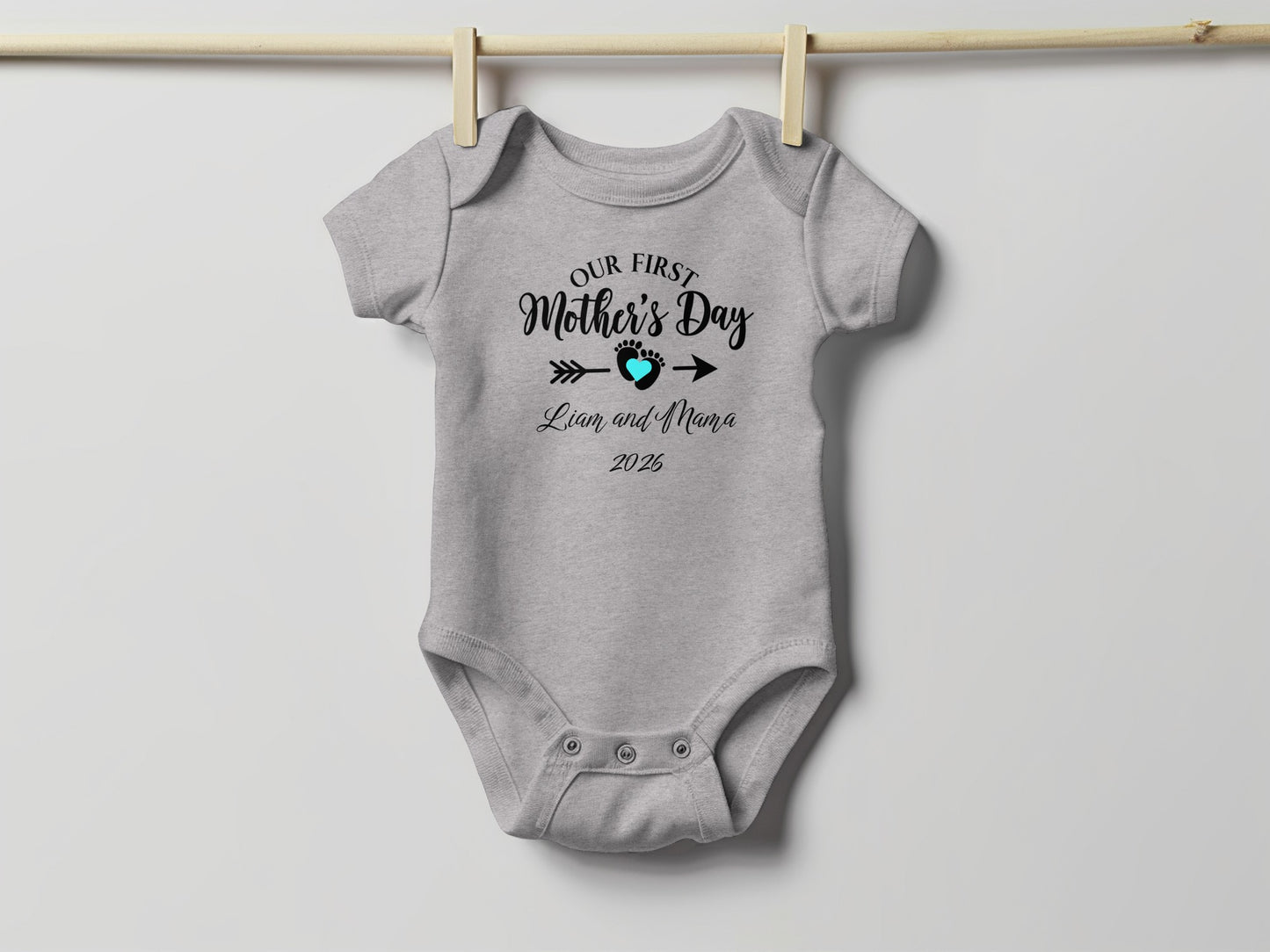 Gray baby onesie with "Our First Mother's Day Liam and Nana 2025" text.