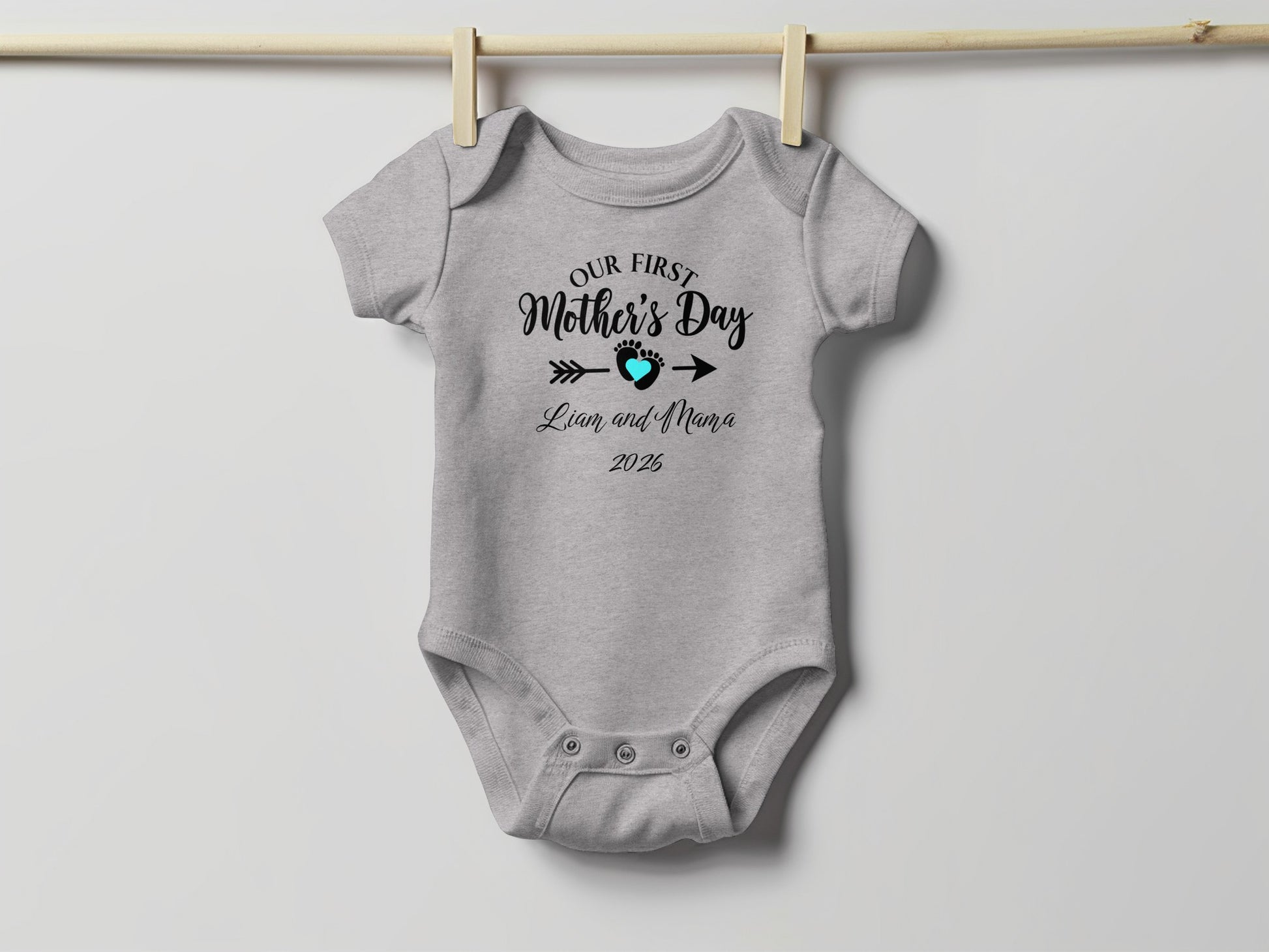 Gray baby onesie with "Our First Mother's Day Liam and Nana 2025" text.