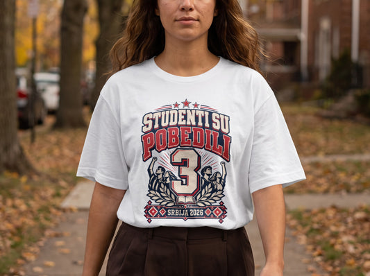 A person wearing a white t-shirt featuring the text "STUDENTI SU POBEDILI" and "SRBIJA 2026."