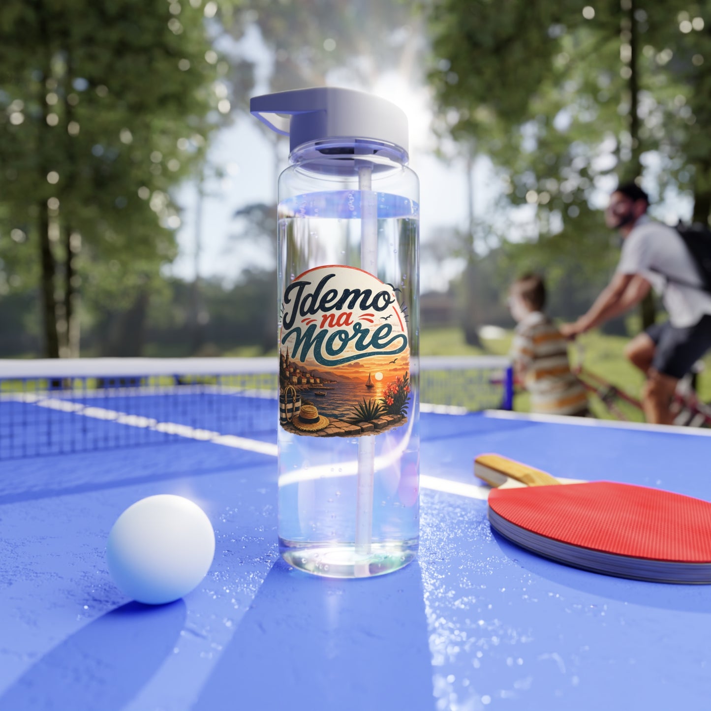 Clear water bottle with "Idemo na More" text over a beach scene on a ping pong table.