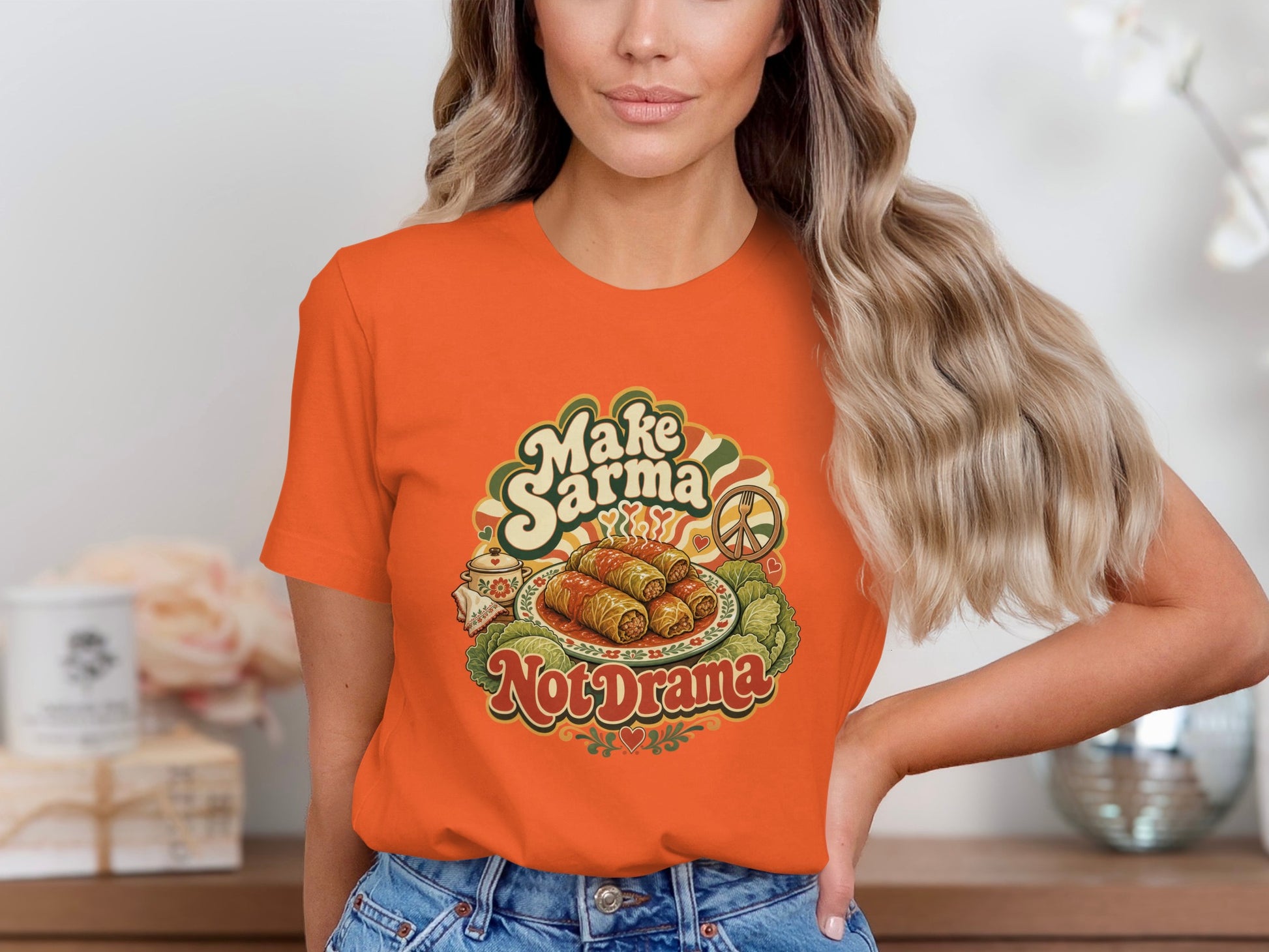 Orange t-shirt with "Make Sarma Not Drama" text and food graphic.