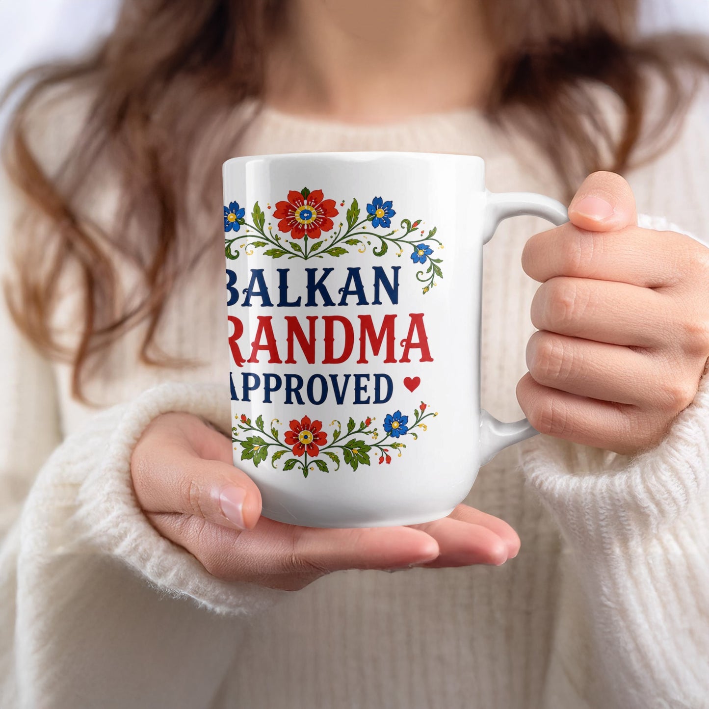 White mug with "BALKAN GRANDMA APPROVED" text and floral design.