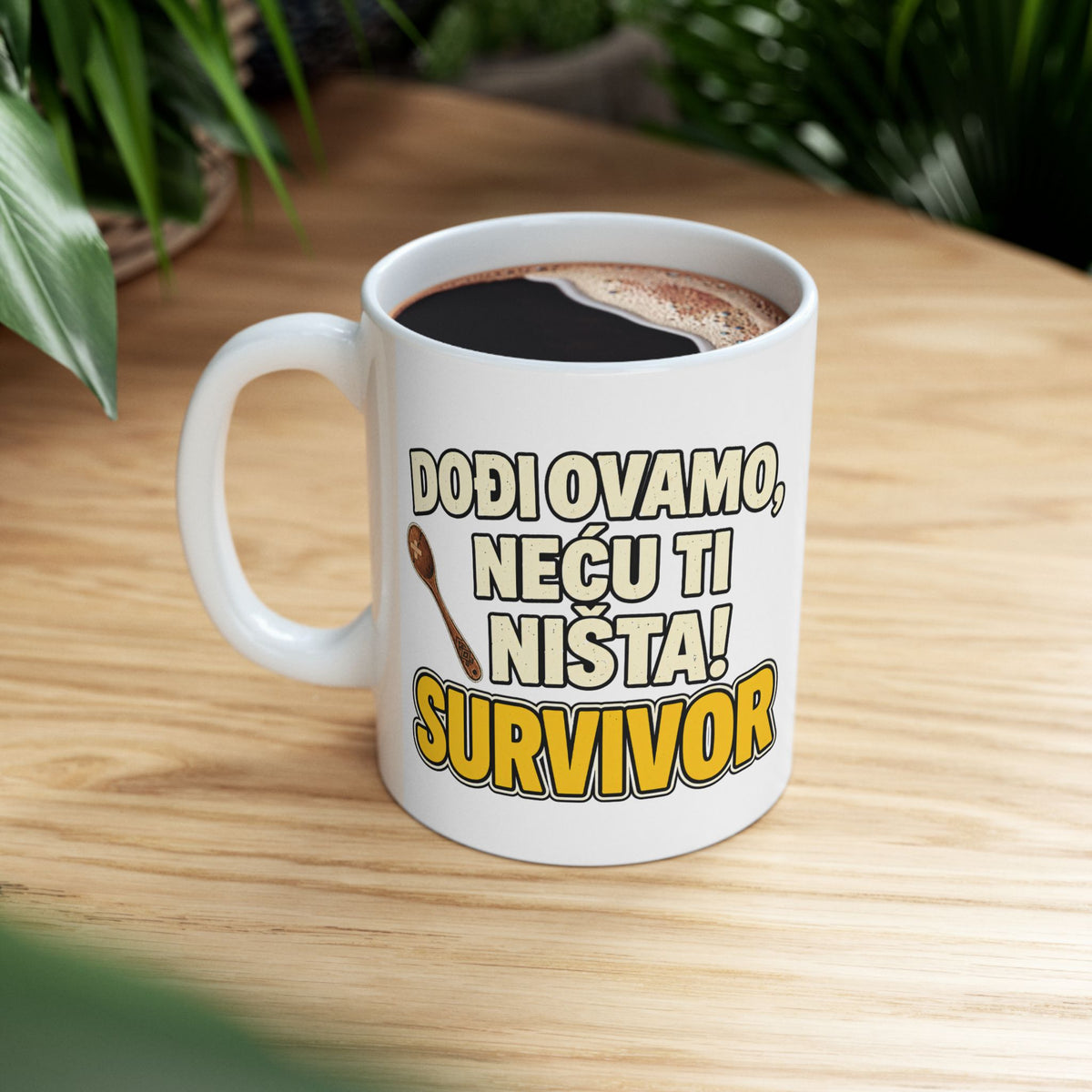 White mug with "DOĐI OVAMO, NEĆU TI NIŠTA! SURVIVOR" text and a spoon illustration.